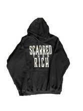 Load image into Gallery viewer, Black sweatshirt with "Scarred then Rich" written in white